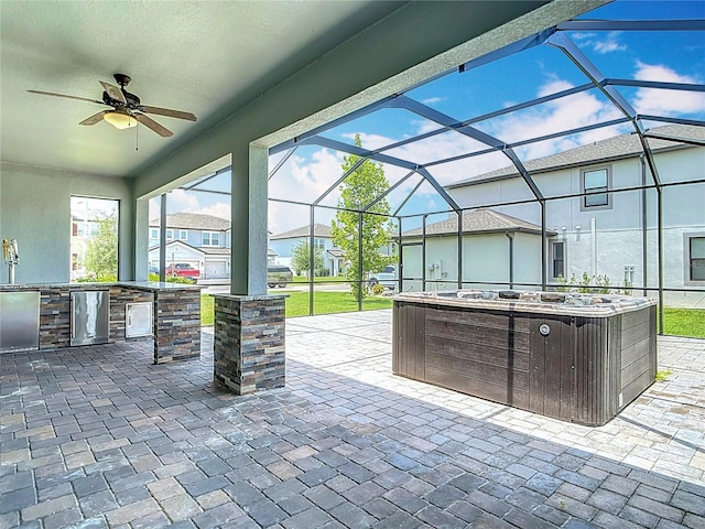 7628 Surf Reed Way, Wesley Chapel, FL 33545 - view of patio / terrace featuring a hot tub, exterior kitchen, a ceiling fan, and a lanai