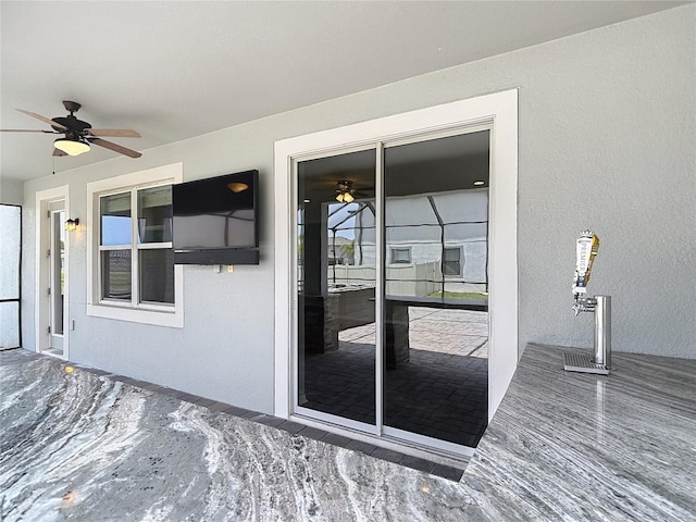 7628 Surf Reed Way, Wesley Chapel, FL 33545 - view of exterior entry with ceiling fan and stucco siding