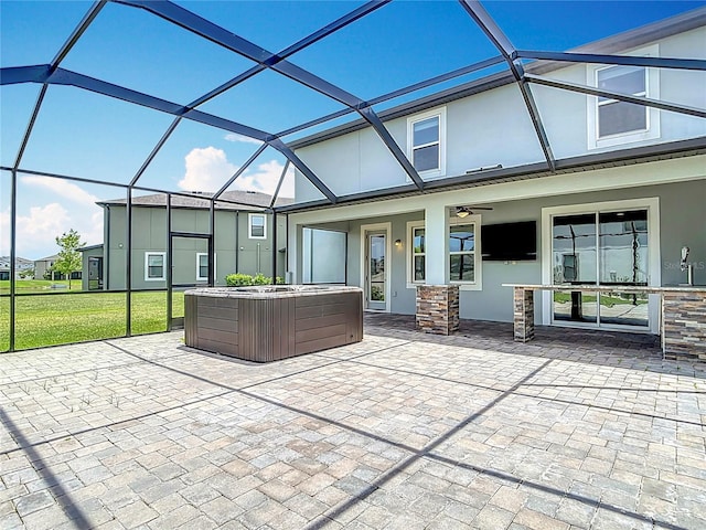7628 Surf Reed Way, Wesley Chapel, FL 33545 - view of patio featuring a hot tub, glass enclosure, and a ceiling fan