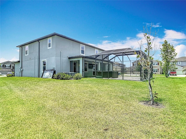 7628 Surf Reed Way, Wesley Chapel, FL 33545 - rear view of house featuring a lawn, stucco siding, and a lanai
