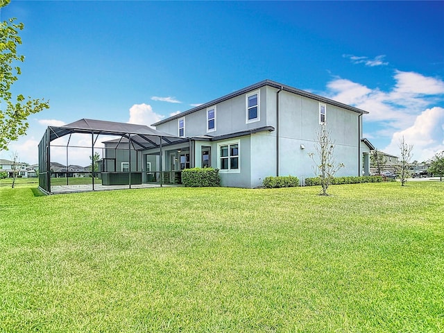 7628 Surf Reed Way, Wesley Chapel, FL 33545 - back of house with stucco siding, a lawn, and a lanai