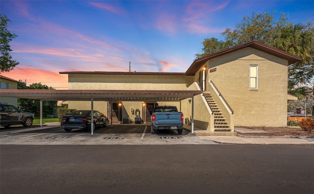 501 E Bay Dr Unit 102, Largo, FL 33770 - parking at dusk with stairs and covered parking