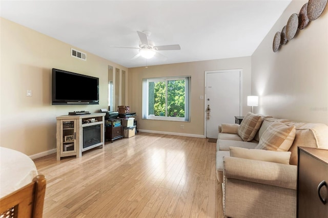 501 E Bay Dr Unit 102, Largo, FL 33770 - living room with a ceiling fan, light wood finished floors, and baseboards