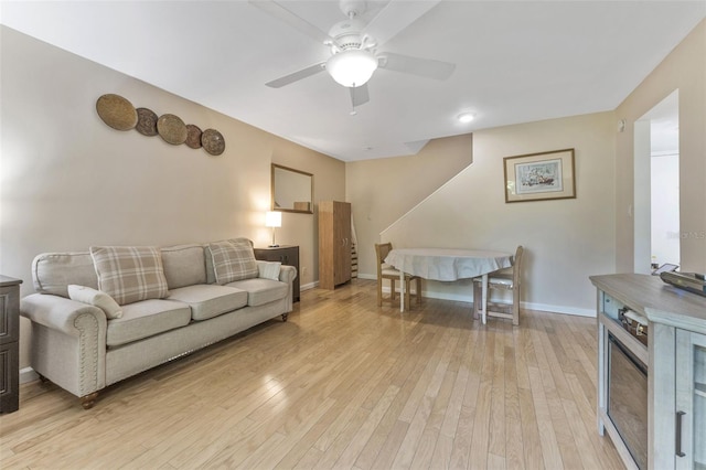 501 E Bay Dr Unit 102, Largo, FL 33770 - living room featuring a ceiling fan, light wood-style flooring, and baseboards
