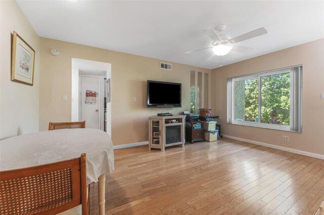 501 E Bay Dr Unit 102, Largo, FL 33770 - dining space featuring a ceiling fan, light wood finished floors, and baseboards