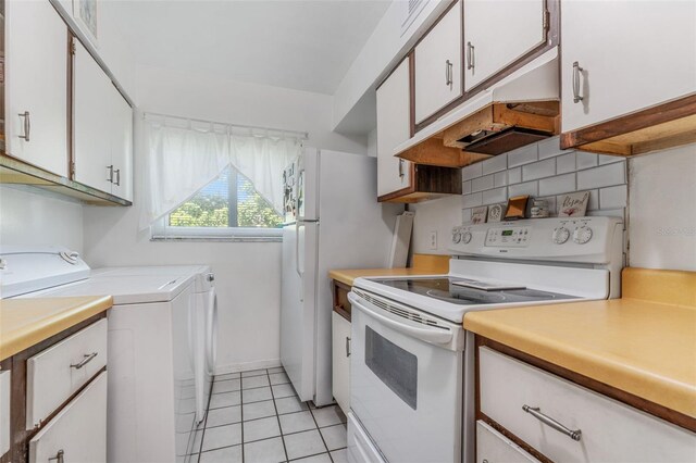 501 E Bay Dr Unit 102, Largo, FL 33770 - kitchen featuring electric stove, independent washer and dryer, light countertops, and white cabinets