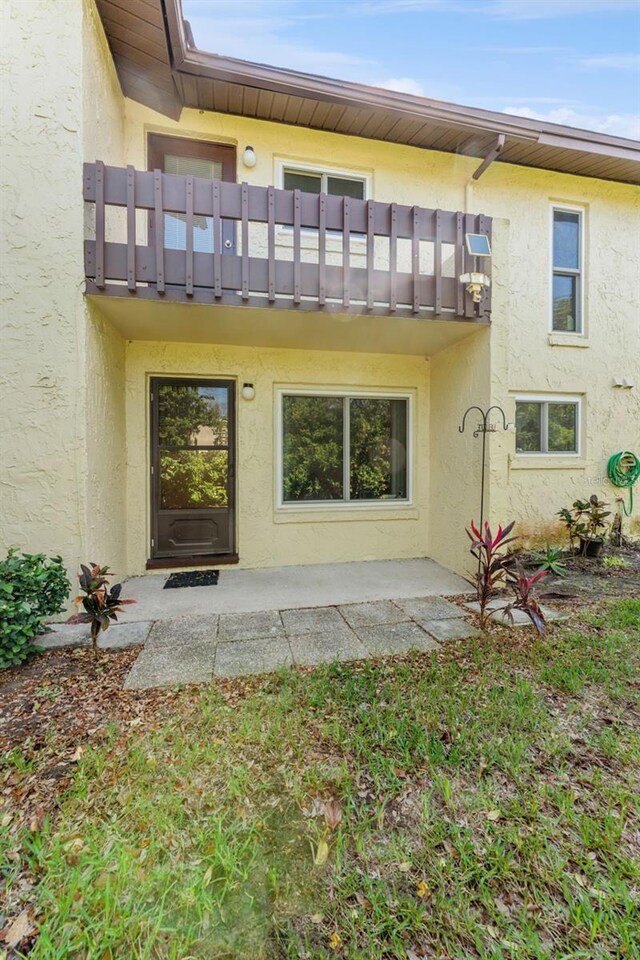 501 E Bay Dr Unit 102, Largo, FL 33770 - rear view of house with a balcony and stucco siding