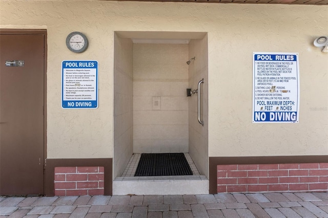 501 E Bay Dr Unit 102, Largo, FL 33770 - doorway to property featuring stucco siding