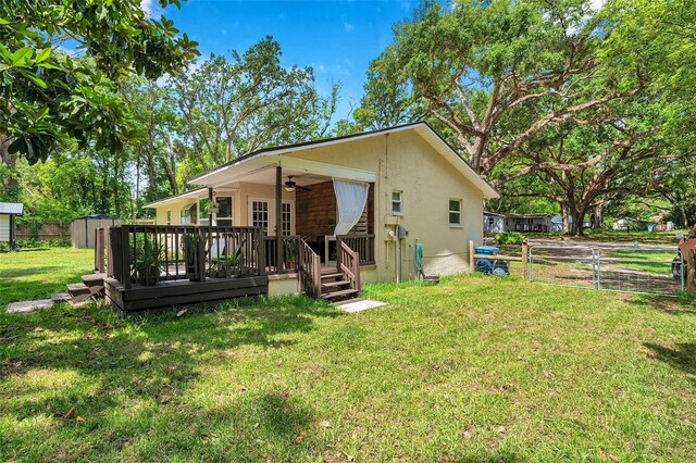 316 Jenkins Ave, Brooksville, FL 34604 - view of front facade featuring ceiling fan, a wooden deck, and stucco siding
