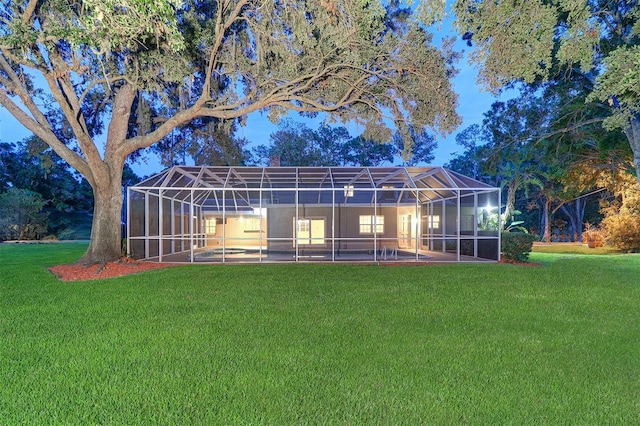 1670 Fox Rd, Clearwater, FL 33764 - rear view of property with a lawn, glass enclosure, and a pool