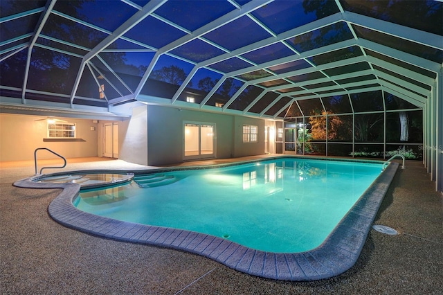 1670 Fox Rd, Clearwater, FL 33764 - pool at twilight featuring a pool with connected hot tub, a patio, and glass enclosure