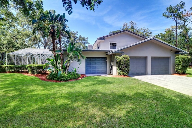 1670 Fox Rd, Clearwater, FL 33764 - view of front of home with a front lawn, a garage, driveway, and stucco siding