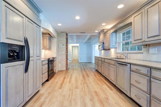 1670 Fox Rd, Clearwater, FL 33764 - kitchen featuring appliances with stainless steel finishes, light wood-type flooring, baseboards, arched walkways, and backsplash