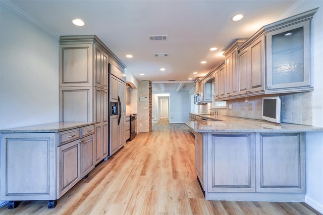 1670 Fox Rd, Clearwater, FL 33764 - kitchen with a sink, recessed lighting, light wood-type flooring, a peninsula, and light stone countertops