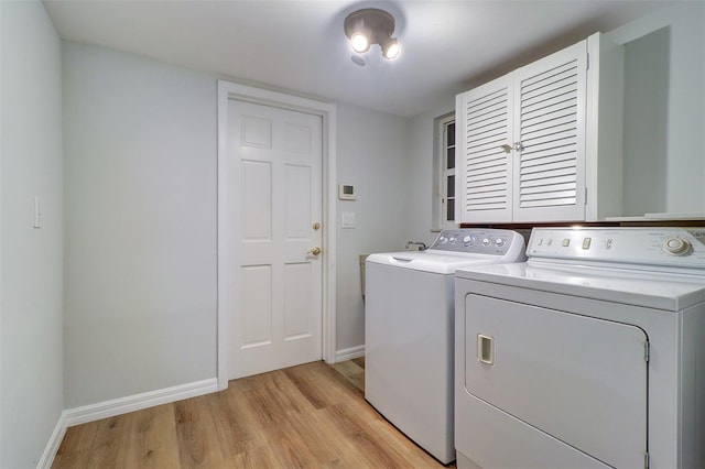 1670 Fox Rd, Clearwater, FL 33764 - washroom featuring independent washer and dryer, light wood finished floors, and baseboards
