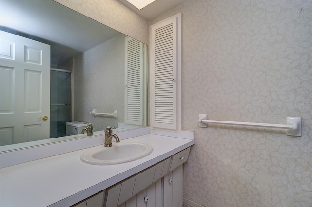 1670 Fox Rd, Clearwater, FL 33764 - full bath featuring vanity, an enclosed shower, wallpapered walls, and toilet