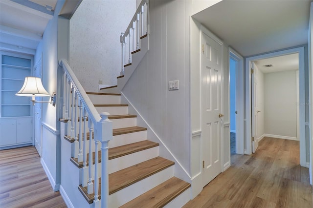 1670 Fox Rd, Clearwater, FL 33764 - staircase featuring wood finished floors, baseboards, and built in features