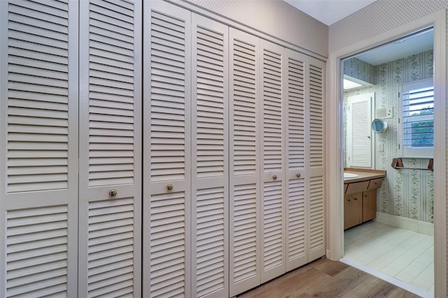 1670 Fox Rd, Clearwater, FL 33764 - corridor with wallpapered walls, wood finished floors, and baseboards