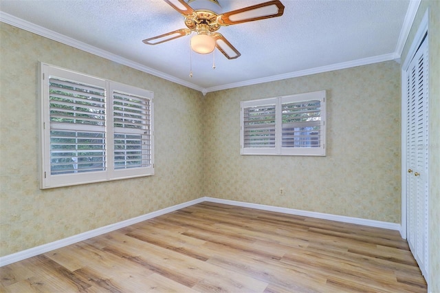 1670 Fox Rd, Clearwater, FL 33764 - unfurnished bedroom with multiple windows, wood finished floors, ornamental molding, a closet, and a textured ceiling