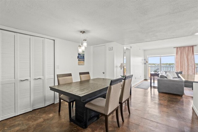 7432 Sunshine Skyway Ln S Unit 402, Saint Petersburg, FL 33711 - dining room with a textured ceiling, baseboards, and finished concrete flooring