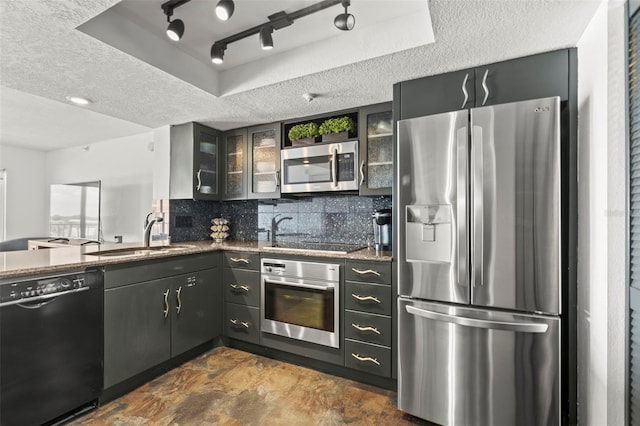 7432 Sunshine Skyway Ln S Unit 402, Saint Petersburg, FL 33711 - kitchen featuring black appliances, a sink, tasteful backsplash, dark stone counters, and glass insert cabinets