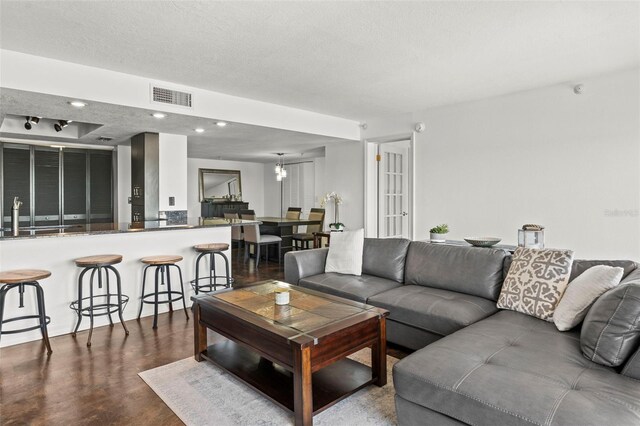 7432 Sunshine Skyway Ln S Unit 402, Saint Petersburg, FL 33711 - living area featuring dark wood-type flooring, recessed lighting, and a textured ceiling