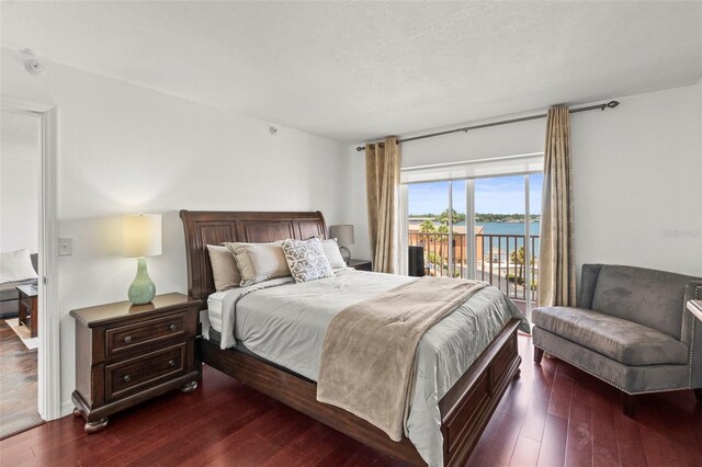 7432 Sunshine Skyway Ln S Unit 402, Saint Petersburg, FL 33711 - bedroom with access to outside and dark wood finished floors