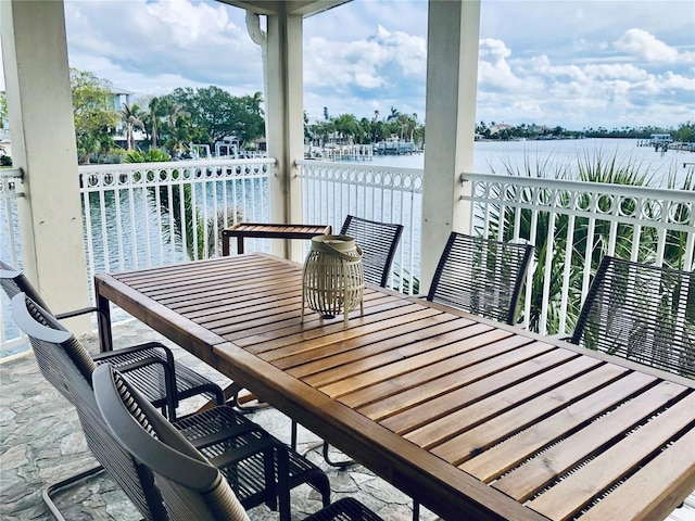 4103 Gulf Blvd Unit 210, St Pete Beach, FL 33706 - balcony with outdoor dining area and a water view