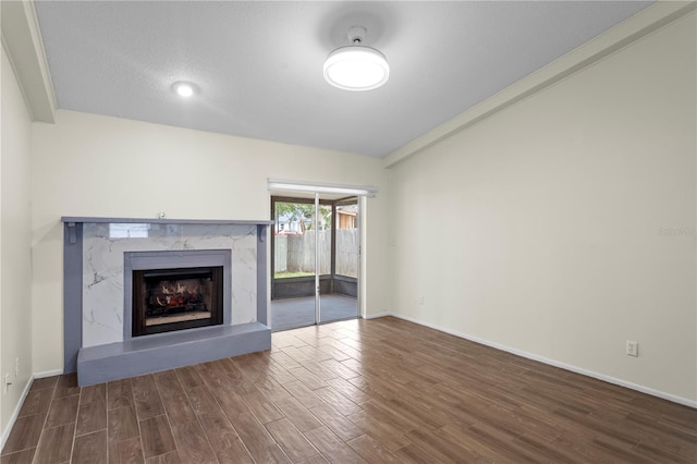 13046 Leverington St, Tampa, FL 33624 - unfurnished living room featuring wood finished floors, a premium fireplace, and baseboards