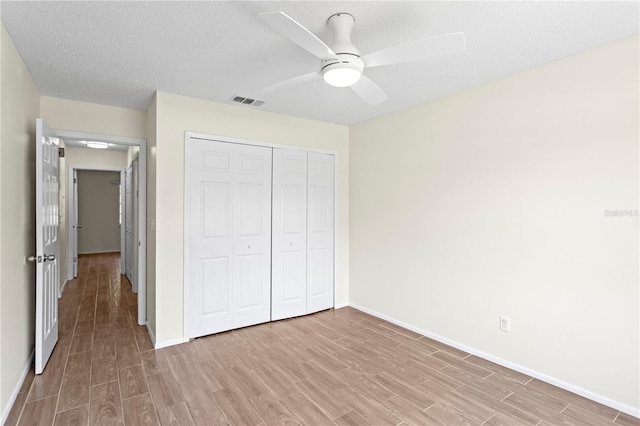 13046 Leverington St, Tampa, FL 33624 - unfurnished bedroom featuring light wood-style floors, baseboards, a closet, and ceiling fan
