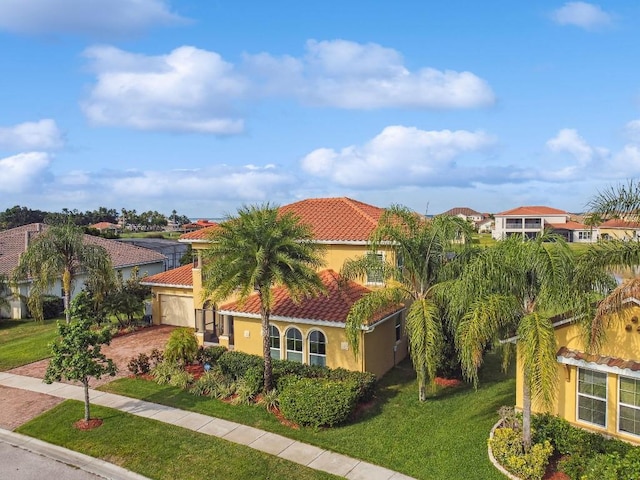 1140 Terralago Way, Kissimmee, FL 34746 - view of front of home featuring a tiled roof, stucco siding, driveway, a front yard, and a residential view
