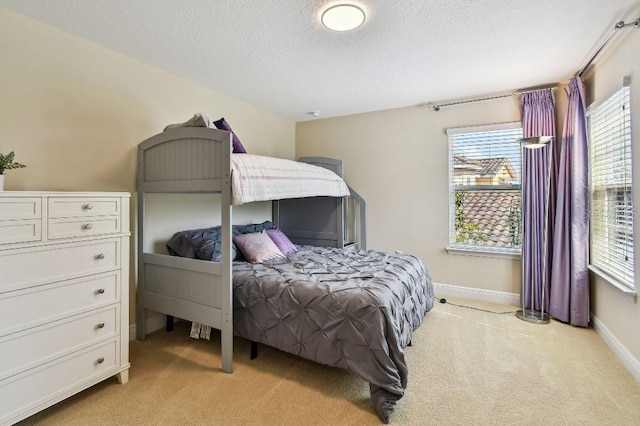 1140 Terralago Way, Kissimmee, FL 34746 - bedroom with light colored carpet, a textured ceiling, and baseboards