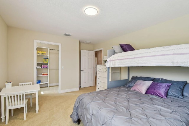 1140 Terralago Way, Kissimmee, FL 34746 - bedroom featuring light colored carpet, a walk in closet, a closet, and baseboards