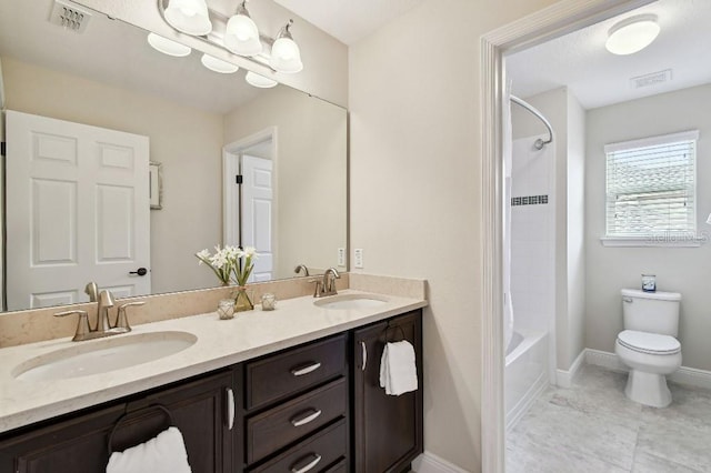 1140 Terralago Way, Kissimmee, FL 34746 - bathroom with double vanity, baseboards, toilet, and tub / shower combination