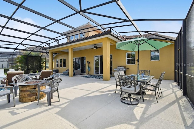 1140 Terralago Way, Kissimmee, FL 34746 - view of patio with an outdoor fire pit, a ceiling fan, outdoor dining space, and a lanai