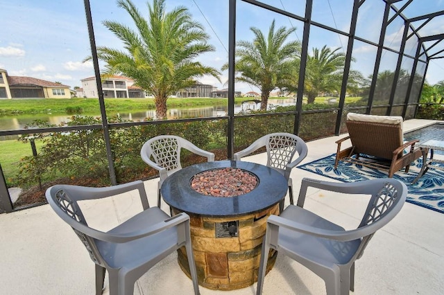 1140 Terralago Way, Kissimmee, FL 34746 - view of patio / terrace featuring an outdoor fire pit, a water view, and a lanai