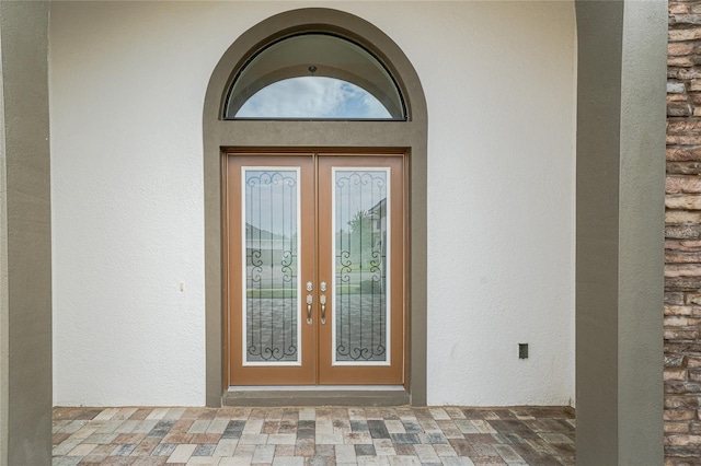 8834 Sanders Tree Loop, Wesley Chapel, FL 33545 - doorway to property with french doors and stucco siding