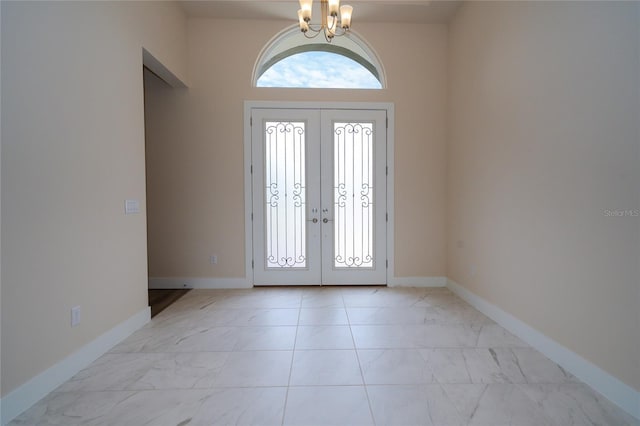 8834 Sanders Tree Loop, Wesley Chapel, FL 33545 - foyer featuring a chandelier, french doors, baseboards, and light marble finish floors