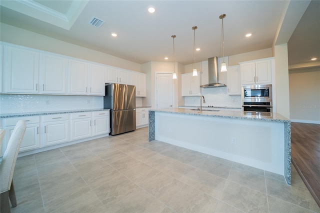 8834 Sanders Tree Loop, Wesley Chapel, FL 33545 - kitchen with wall chimney exhaust hood, stainless steel appliances, a sink, tasteful backsplash, and white cabinets