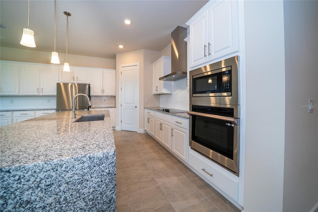 8834 Sanders Tree Loop, Wesley Chapel, FL 33545 - kitchen featuring stainless steel appliances, a sink, wall chimney range hood, tasteful backsplash, and white cabinets