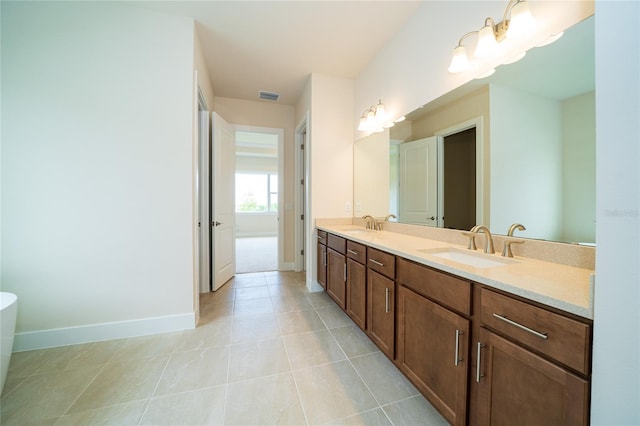 8834 Sanders Tree Loop, Wesley Chapel, FL 33545 - bathroom with double vanity, baseboards, a soaking tub, and tile patterned flooring