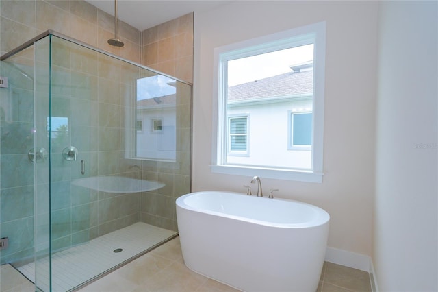8834 Sanders Tree Loop, Wesley Chapel, FL 33545 - full bath featuring a shower stall, a soaking tub, tile patterned flooring, and baseboards