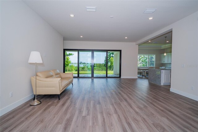 8834 Sanders Tree Loop, Wesley Chapel, FL 33545 - living area with baseboards, wood finished floors, and recessed lighting