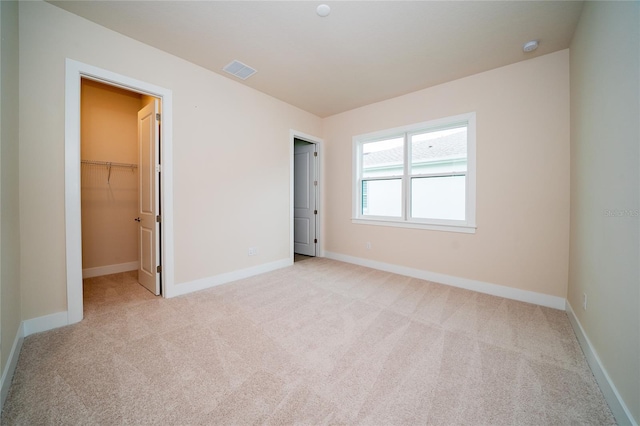 8834 Sanders Tree Loop, Wesley Chapel, FL 33545 - unfurnished bedroom featuring light colored carpet, a spacious closet, and baseboards