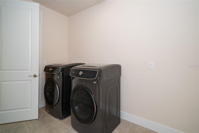 8834 Sanders Tree Loop, Wesley Chapel, FL 33545 - washroom featuring separate washer and dryer, baseboards, and light tile patterned floors