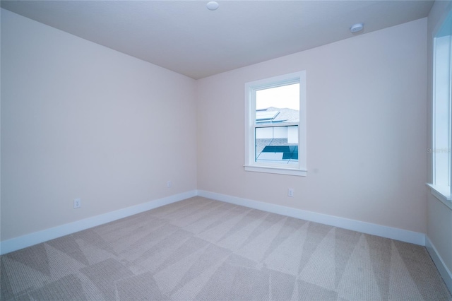 8834 Sanders Tree Loop, Wesley Chapel, FL 33545 - empty room featuring healthy amount of natural light, light carpet, and baseboards