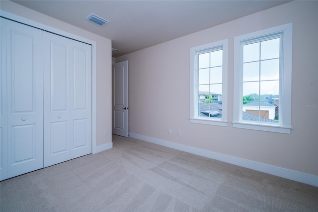 8834 Sanders Tree Loop, Wesley Chapel, FL 33545 - unfurnished bedroom featuring light carpet, baseboards, and a closet