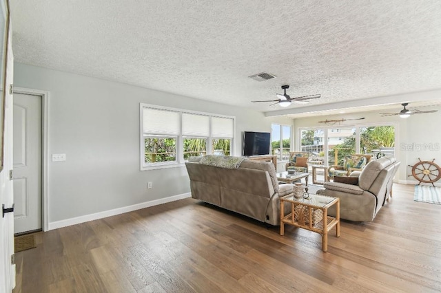 3285 Minnow Creek Dr, Hernando Beach, FL 34607 - living area with ceiling fan, a textured ceiling, plenty of natural light, and wood finished floors