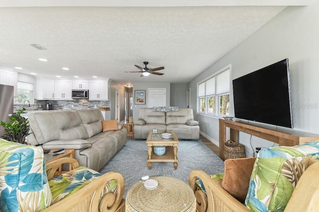 3285 Minnow Creek Dr, Hernando Beach, FL 34607 - living room featuring a ceiling fan, baseboards, plenty of natural light, recessed lighting, and a textured ceiling