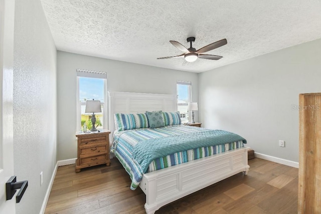 3285 Minnow Creek Dr, Hernando Beach, FL 34607 - bedroom featuring baseboards, hardwood / wood-style floors, a ceiling fan, and a textured ceiling